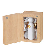 Ange en porcelaine dans sa petite boite en bois.